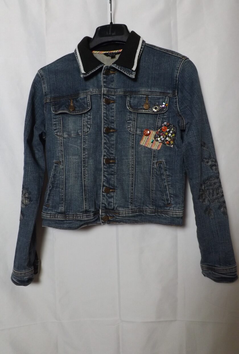 A denim jacket with fabric patches, sequins and rhinestones