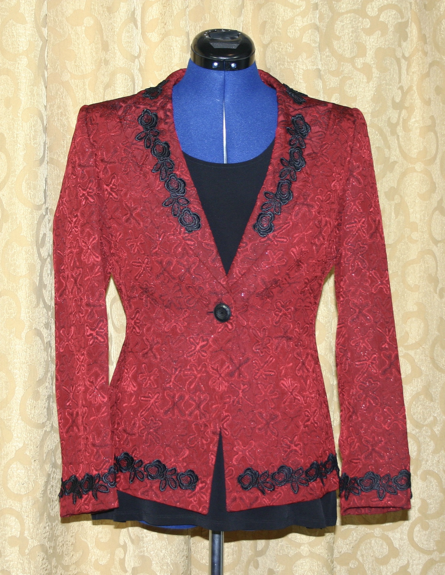 A red and black blazer on a mannequin.