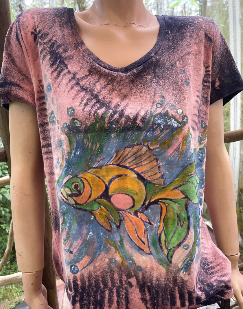 A mannequin wearing a t - shirt with a fish on it.