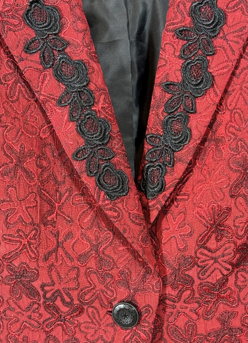 A red blazer with black lace trim.