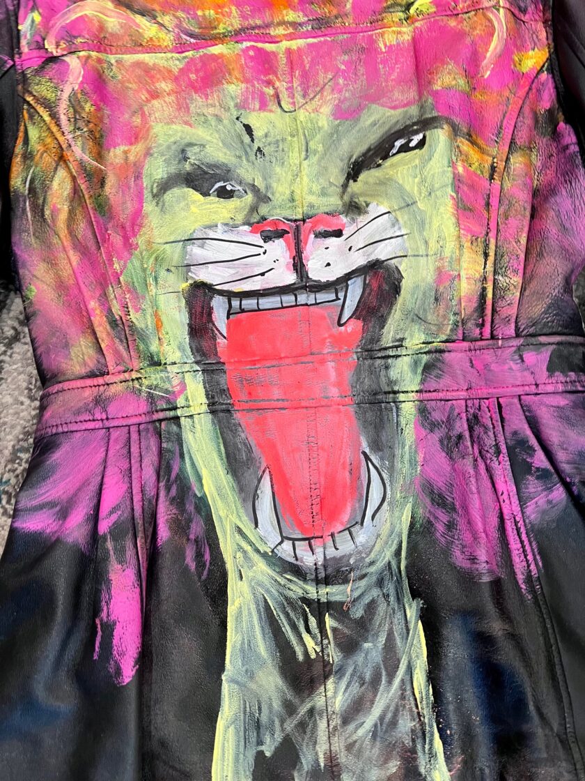 A painted leather jacket with a lion on it.