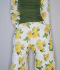 A woman wearing a lemon print pajama set.