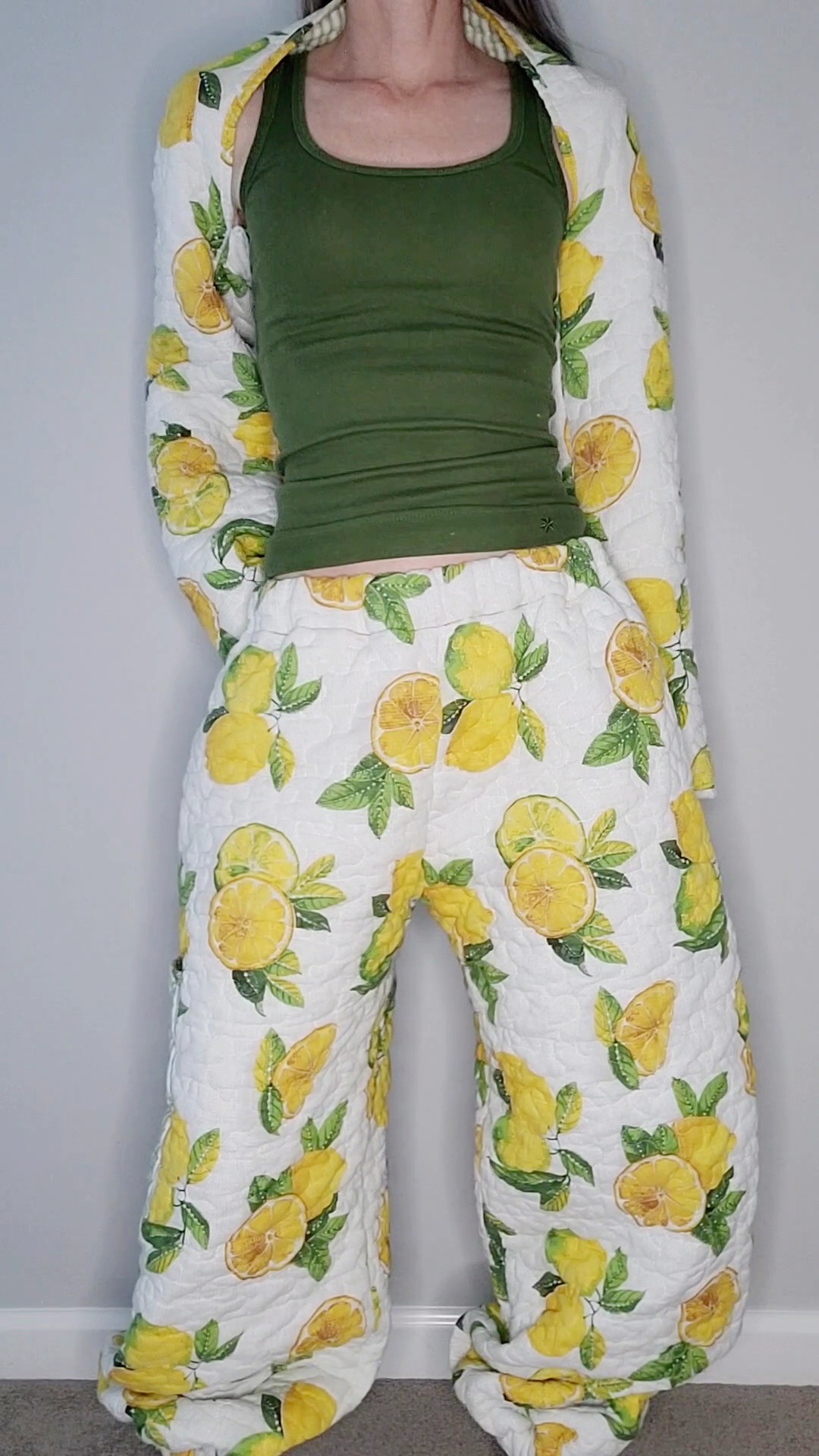 A woman wearing a lemon print pajama set.