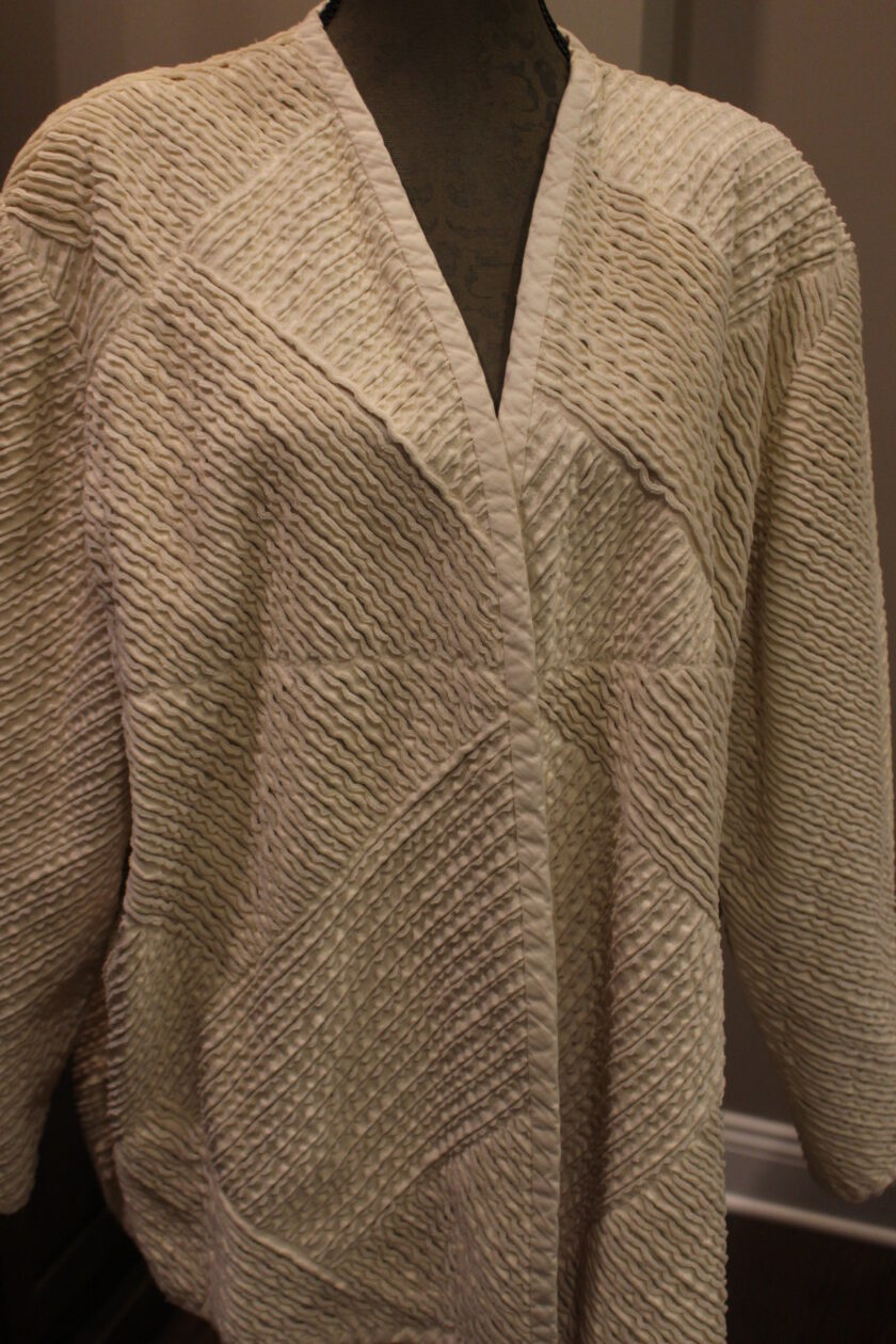 A white jacket on a mannequin mannequin.