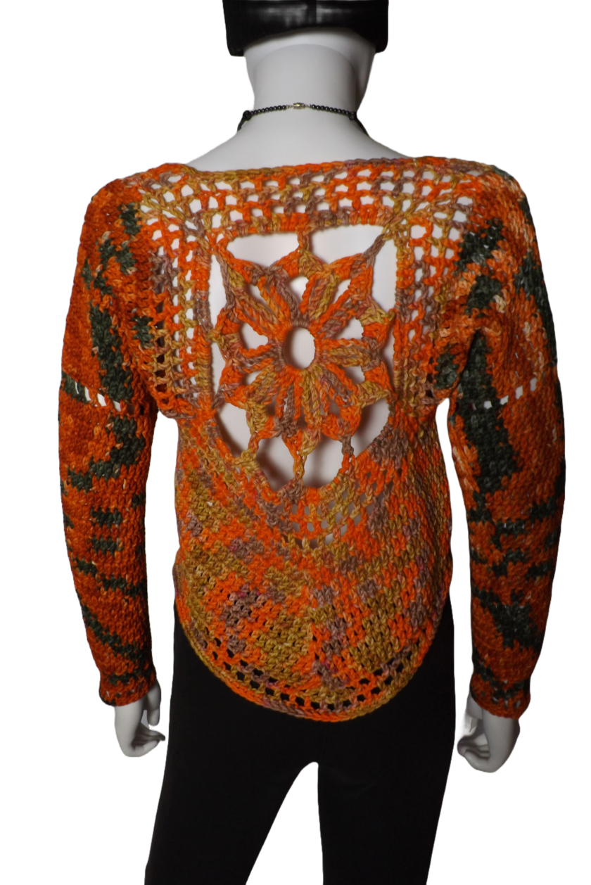 An organic cotton crochet sweater with long sleeves and sun design