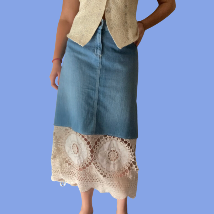 A woman wearing a denim skirt with lace trim.