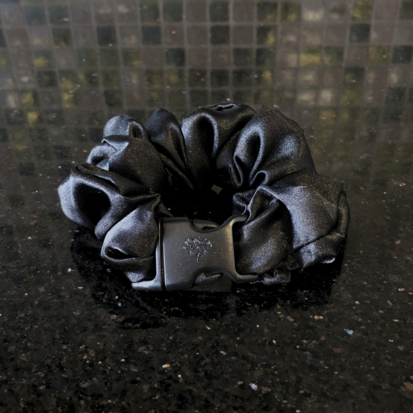 The Original Buckle Scrunchie - Patent-Pending, Recycled on a marble countertop.