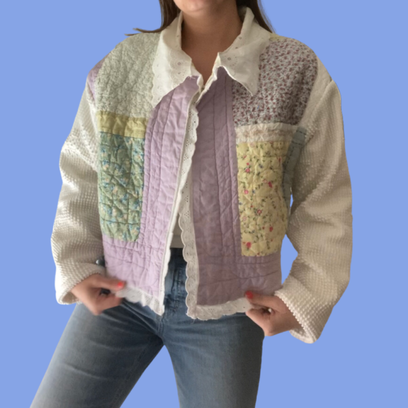 A woman wearing a colorful quilted jacket.