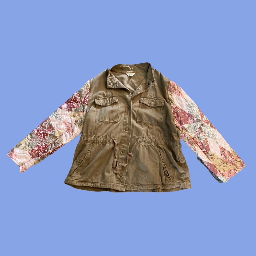 A women's jacket with a patchwork sleeve.