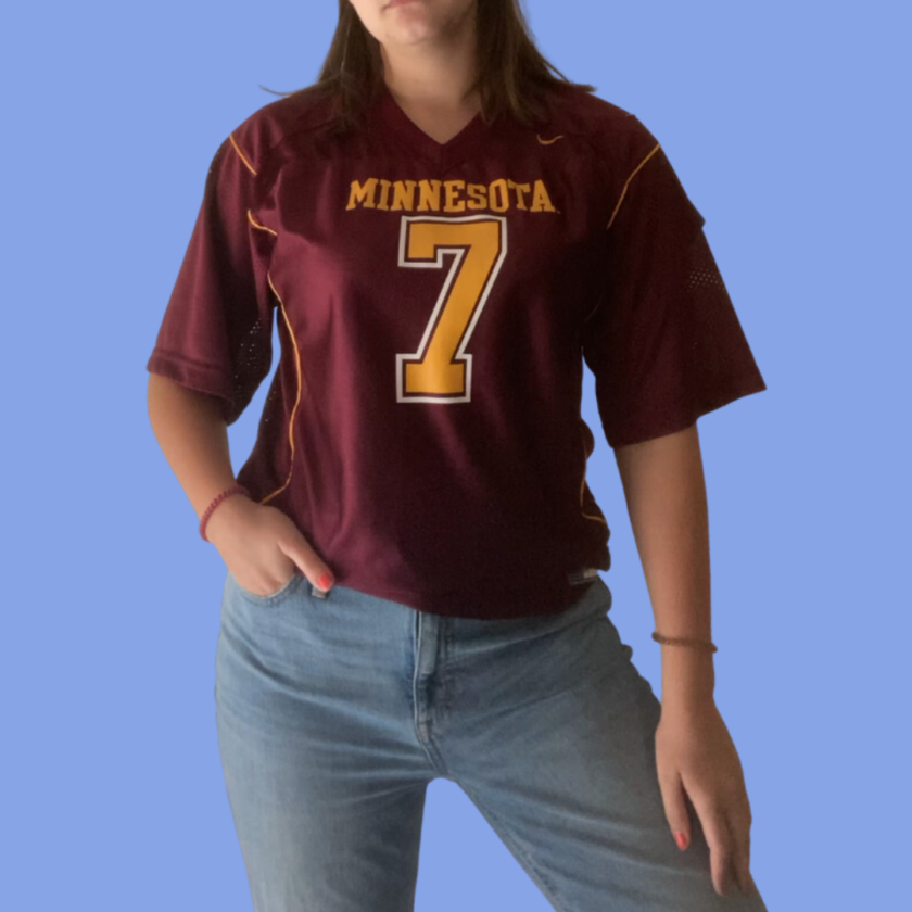 A woman wearing a minnesota football jersey.