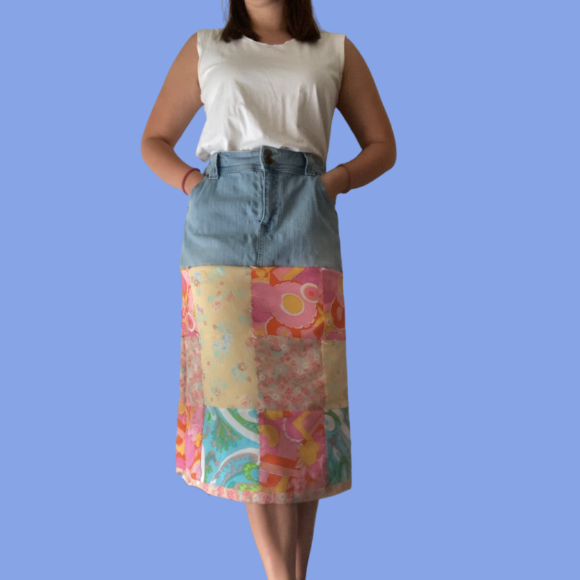 A woman wearing a colorful patchwork skirt.