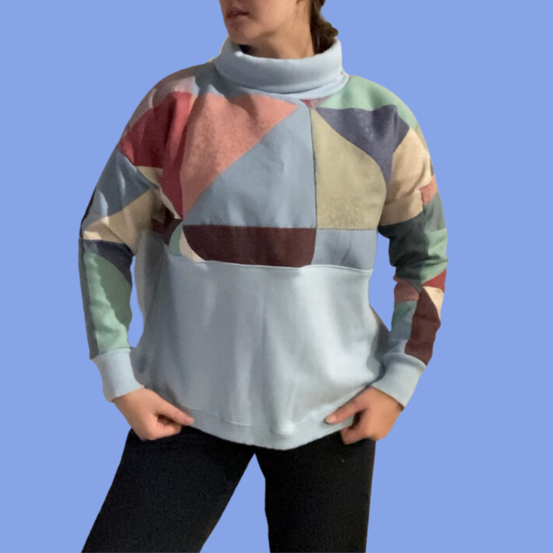 A woman wearing a colorful turtleneck sweater.