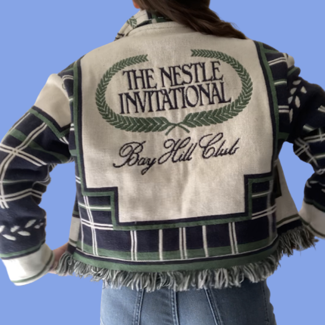A woman wearing a jacket that says the nestle international.