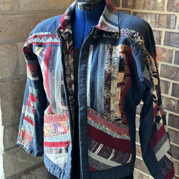 A denim jacket with a patchwork pattern on it.