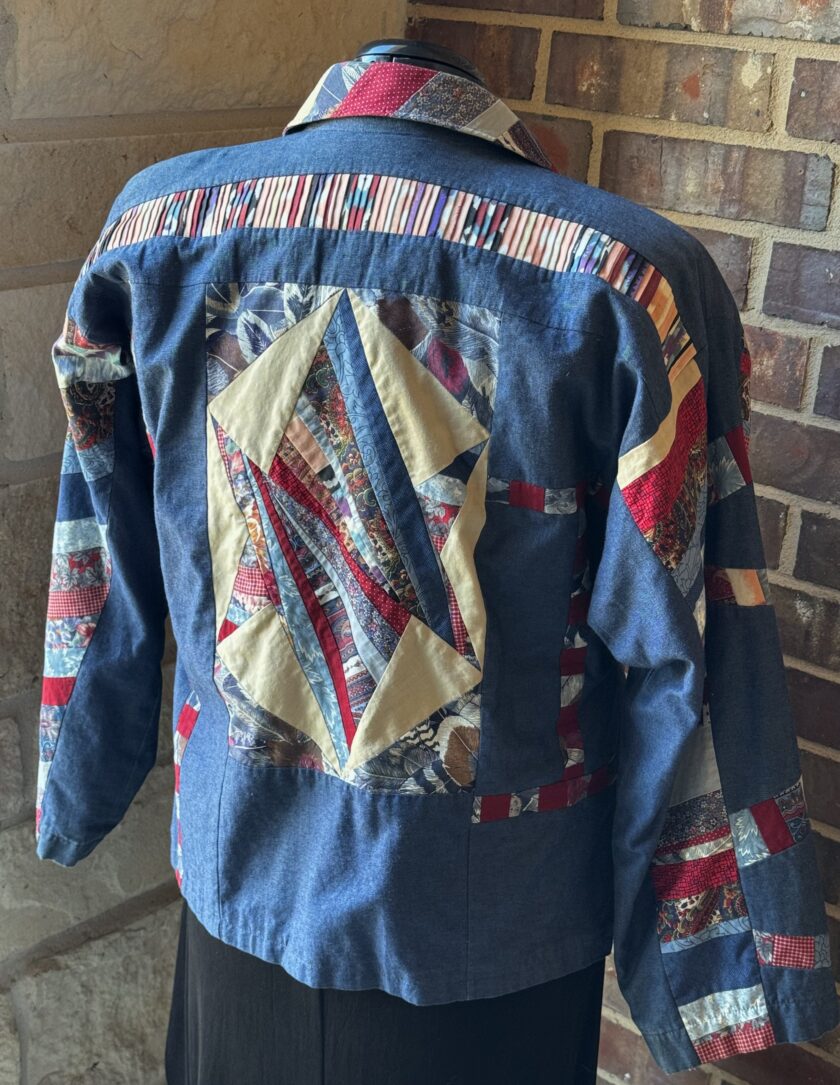 A blue jacket with red, white and blue patches on it.