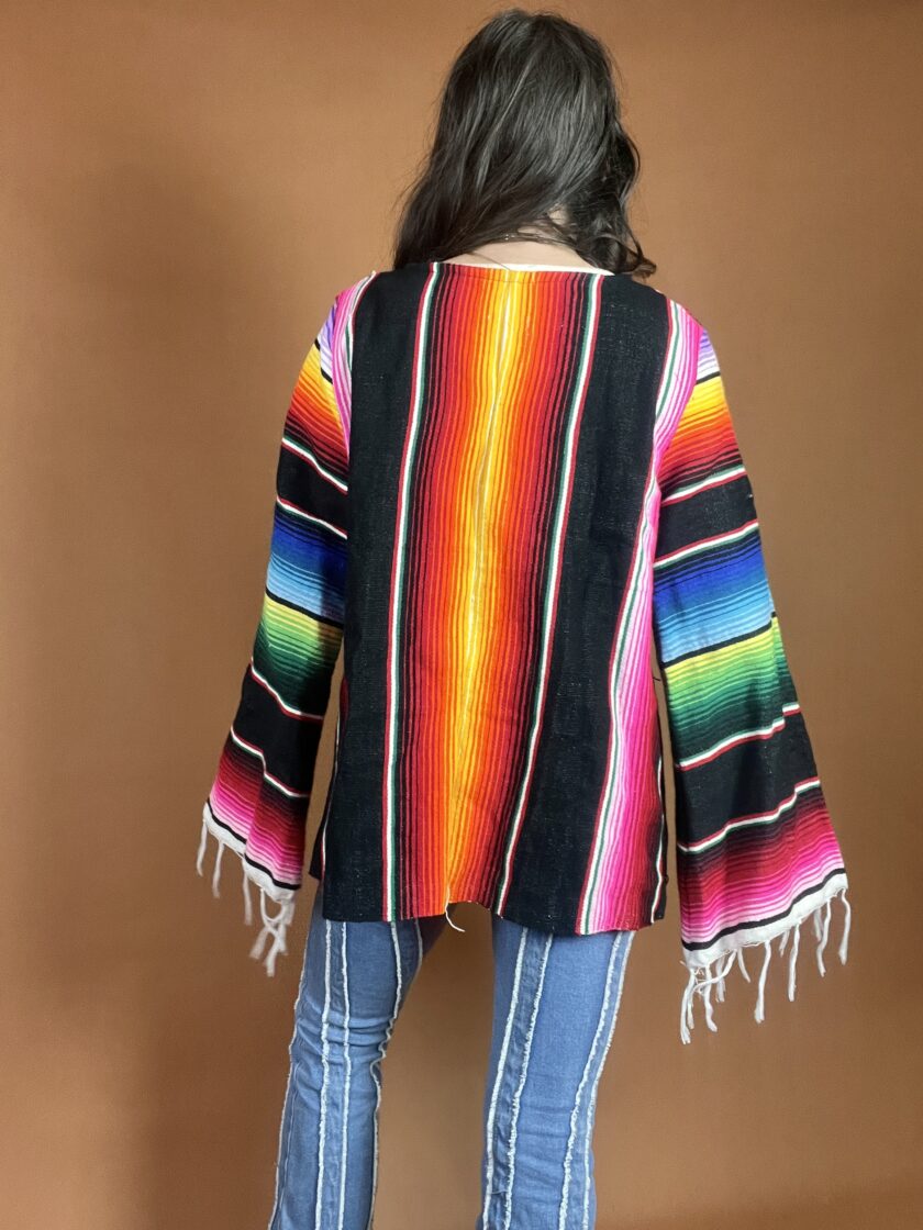 A woman wearing a colorful poncho.