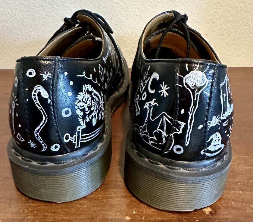 A pair of shoes with drawings on them.