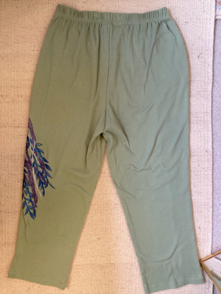 A pair of green pants with a pattern on them.