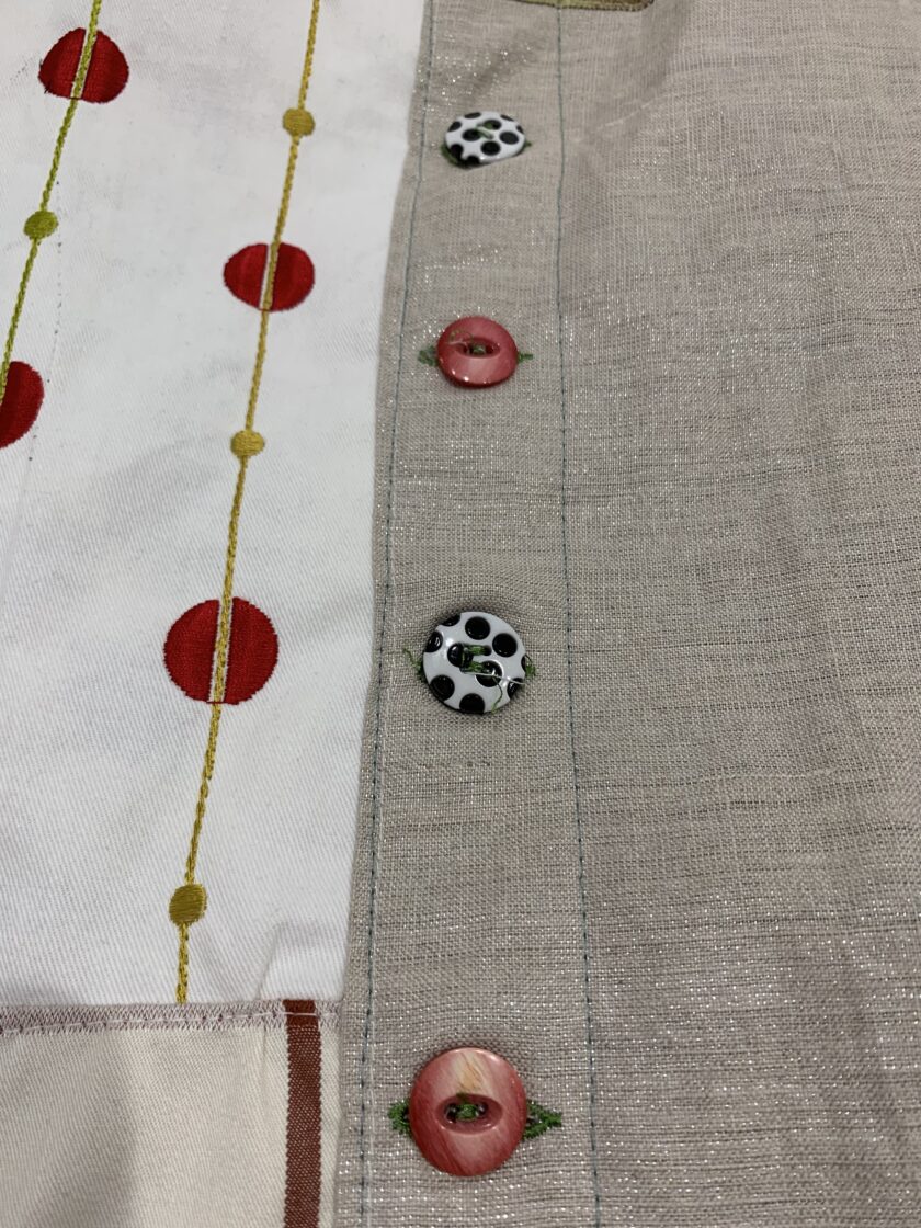A close up of buttons on a piece of fabric.