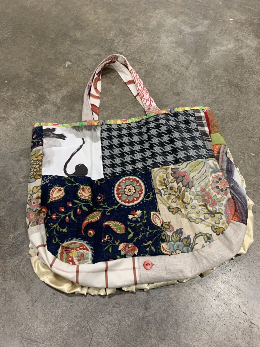 A tote bag with a patchwork pattern on it.