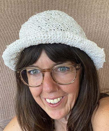 A woman wearing a white knitted hat.