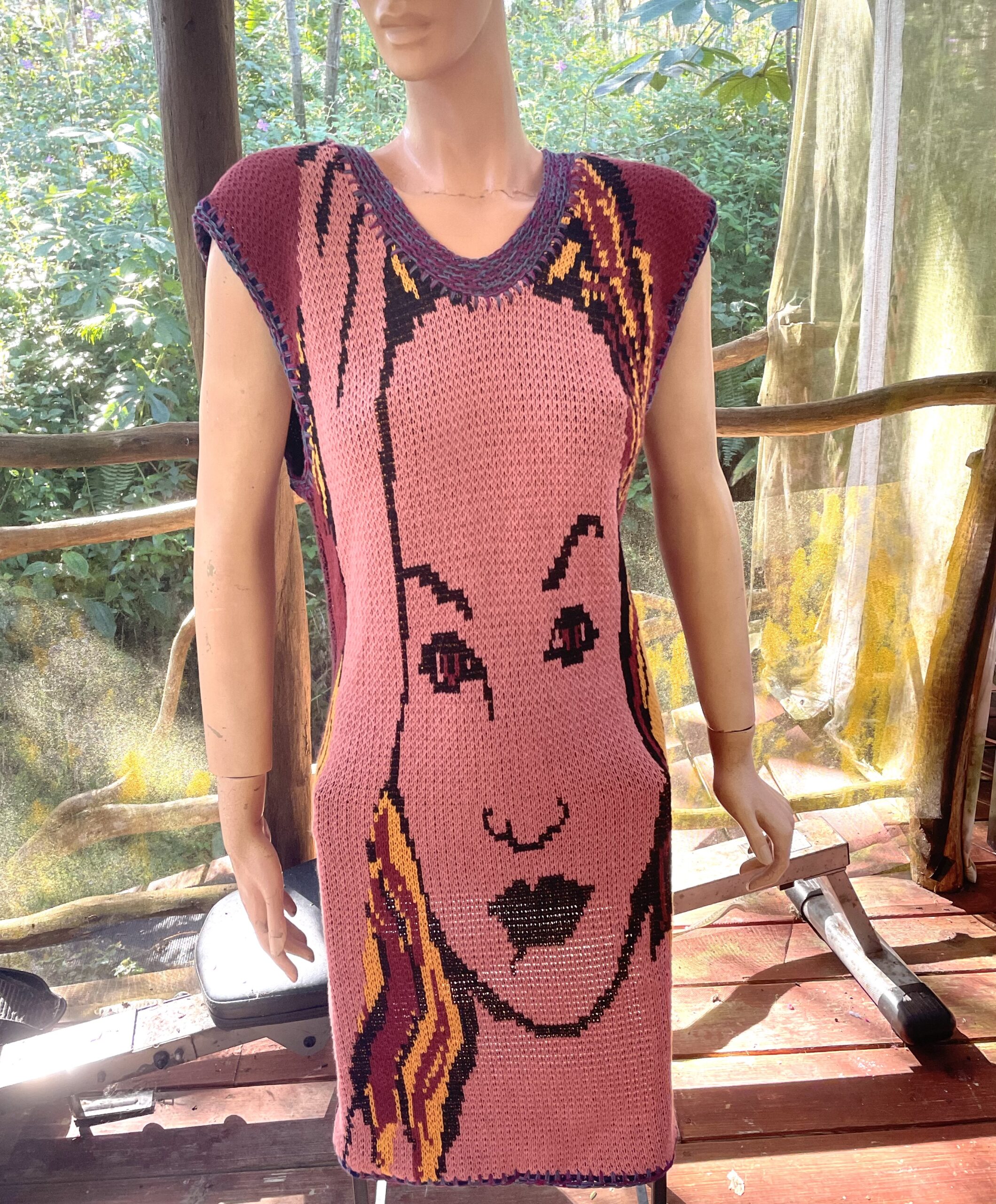 A mannequin wearing a dress with a woman's face on it.