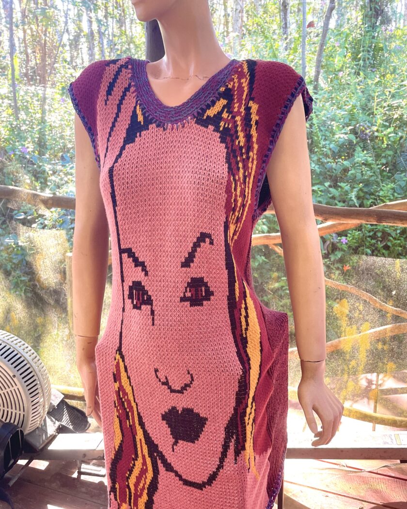 A mannequin wearing a dress with a woman's face on it.