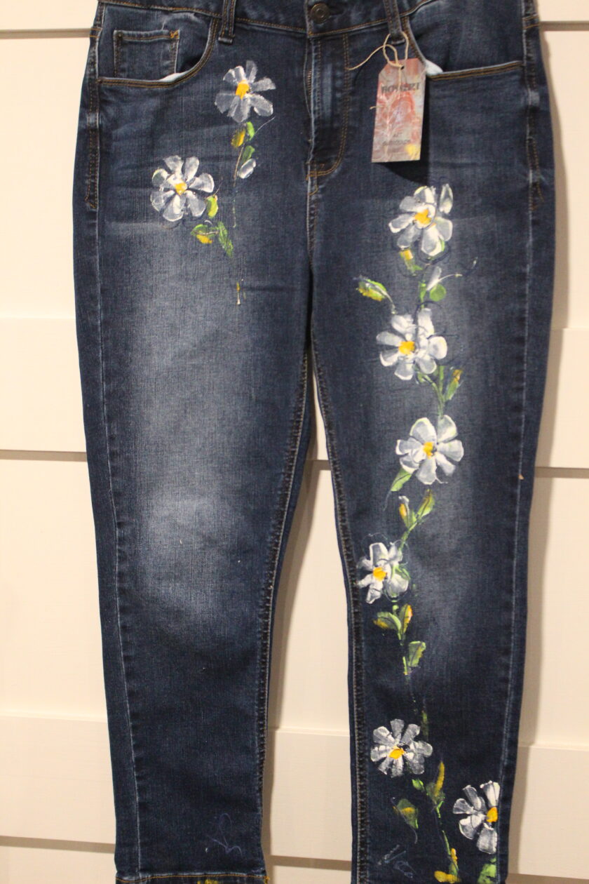 A pair of jeans with flowers on them.