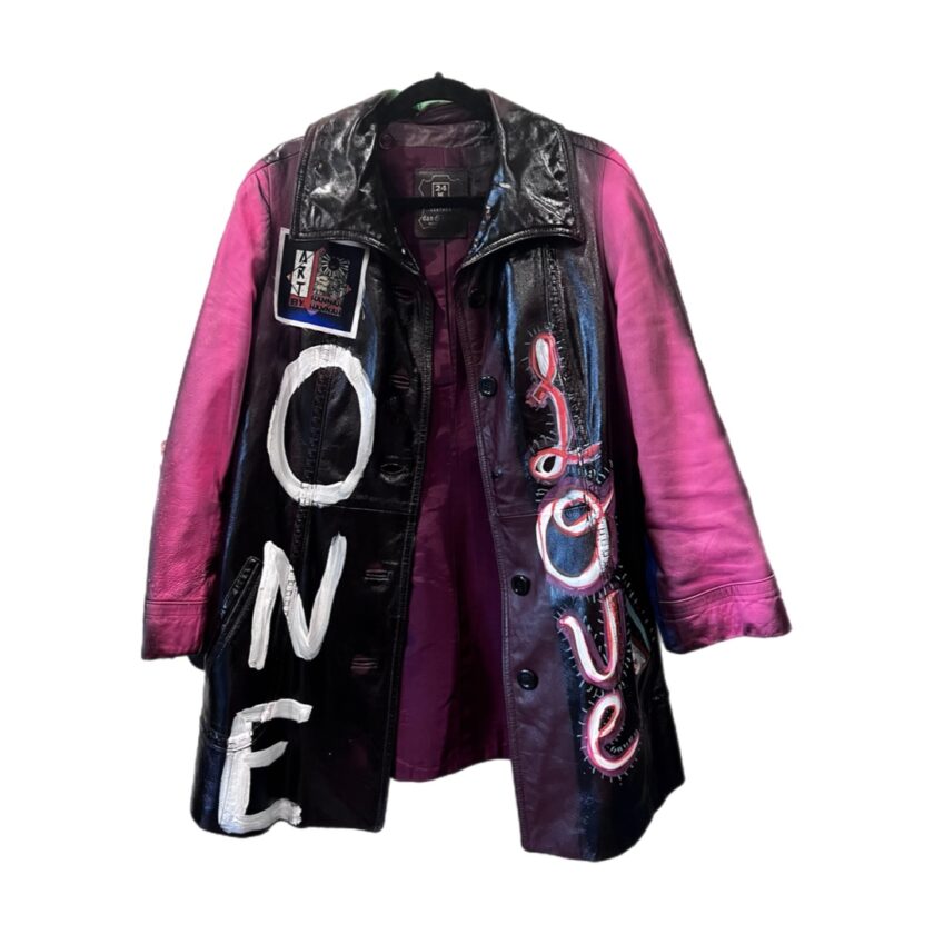 A black and pink leather jacket with the word'love'on it.