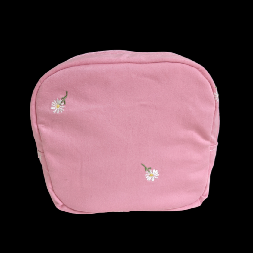 A pink pouch with daisies on it.