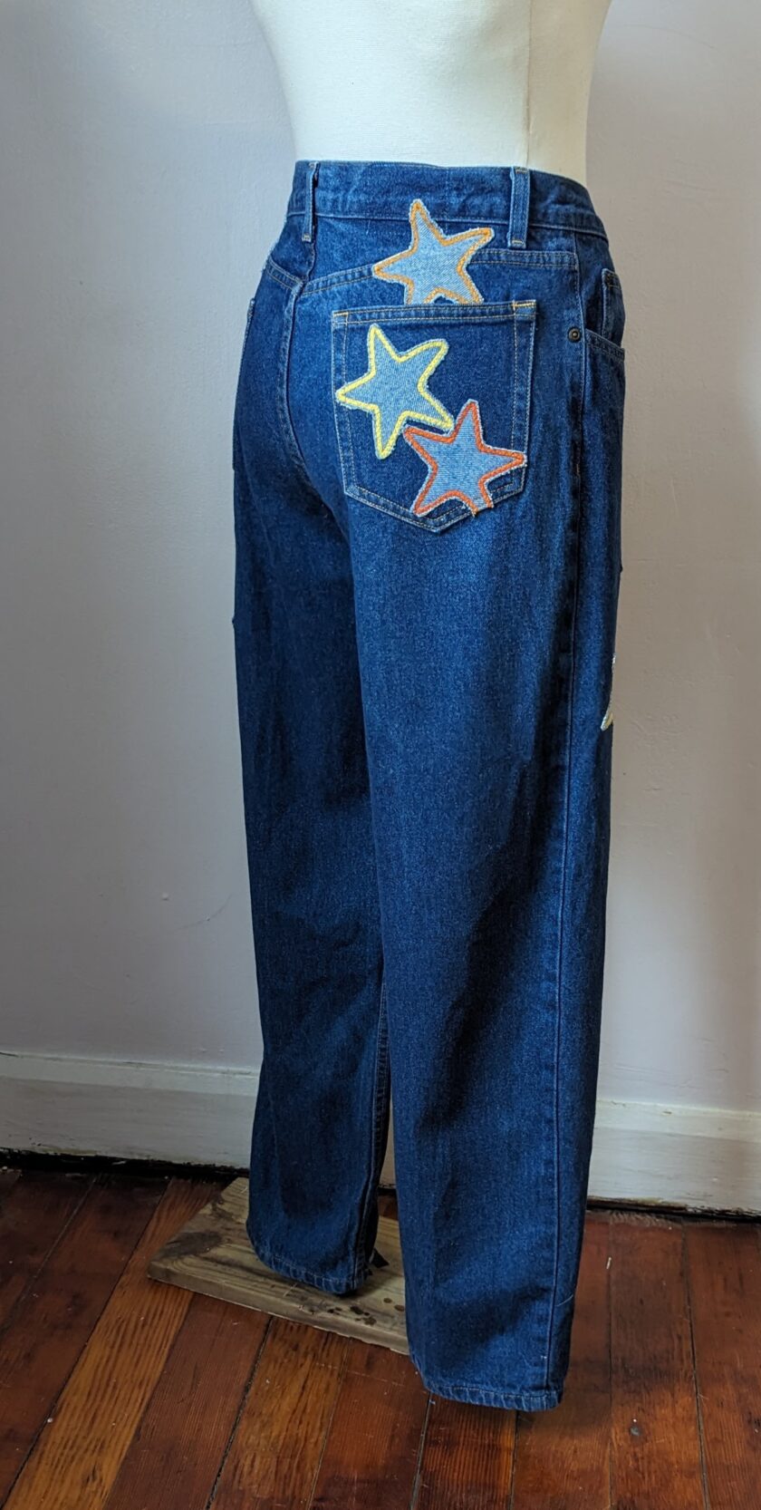 A mannequin wearing a pair of jeans with stars on them.