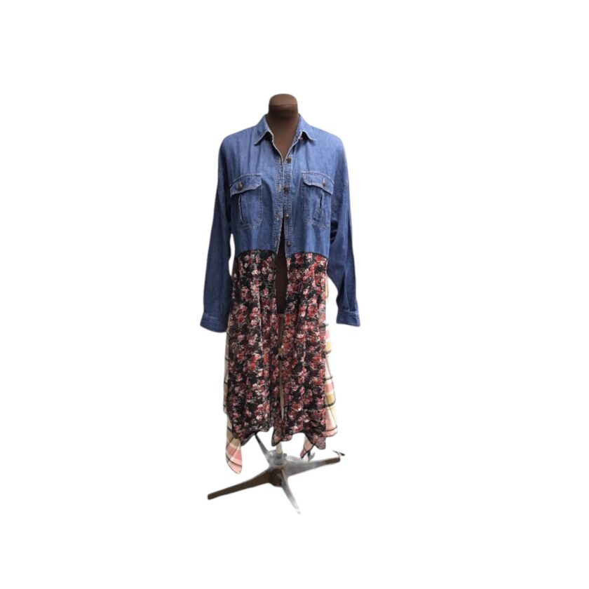 A mannequin mannequin with a denim jacket and floral print dress.