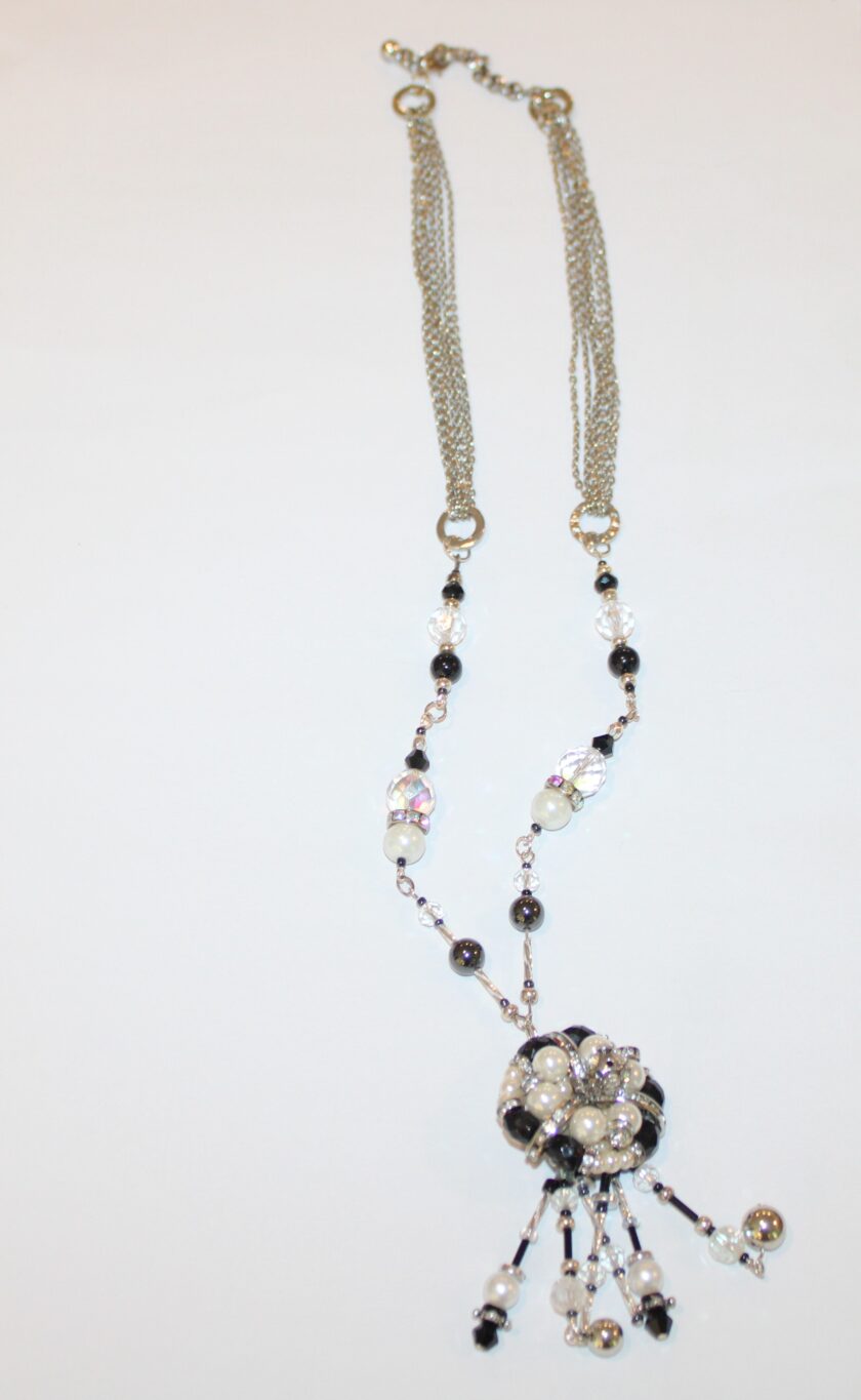A necklace with black and white beads on it.
