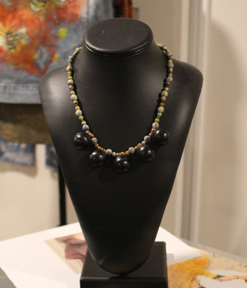 A necklace on a mannequin.