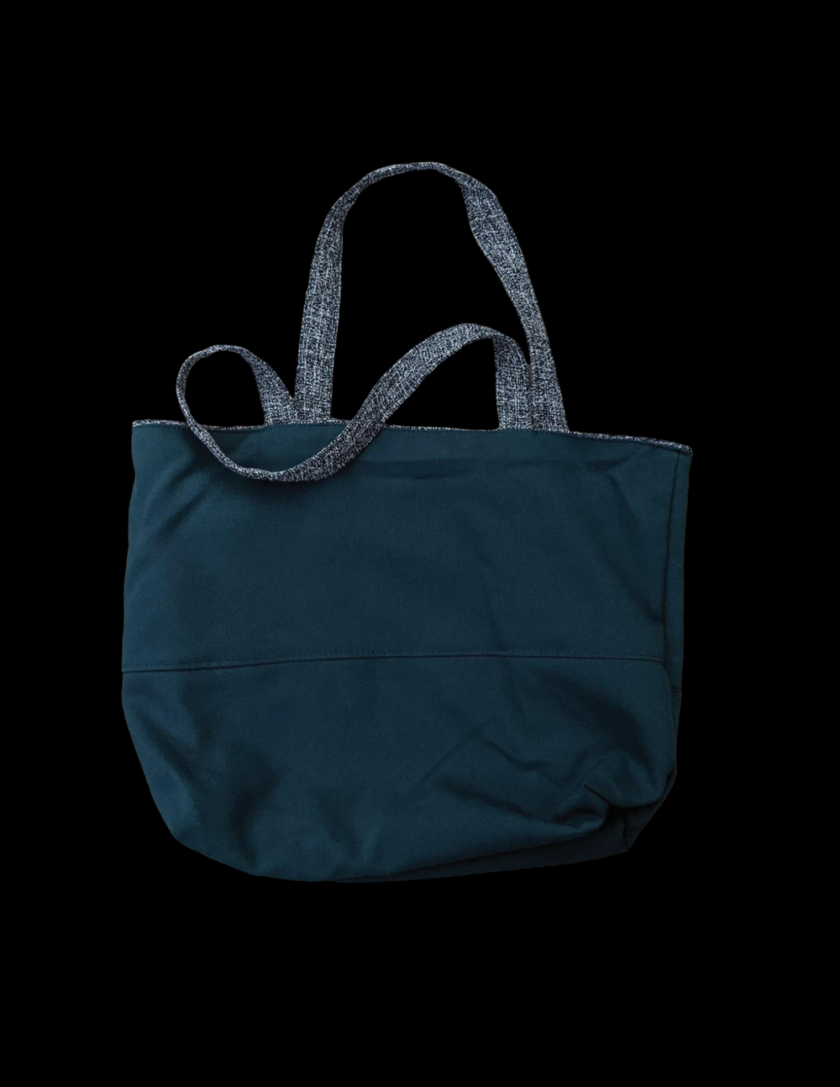 A blue tote bag on a black background.