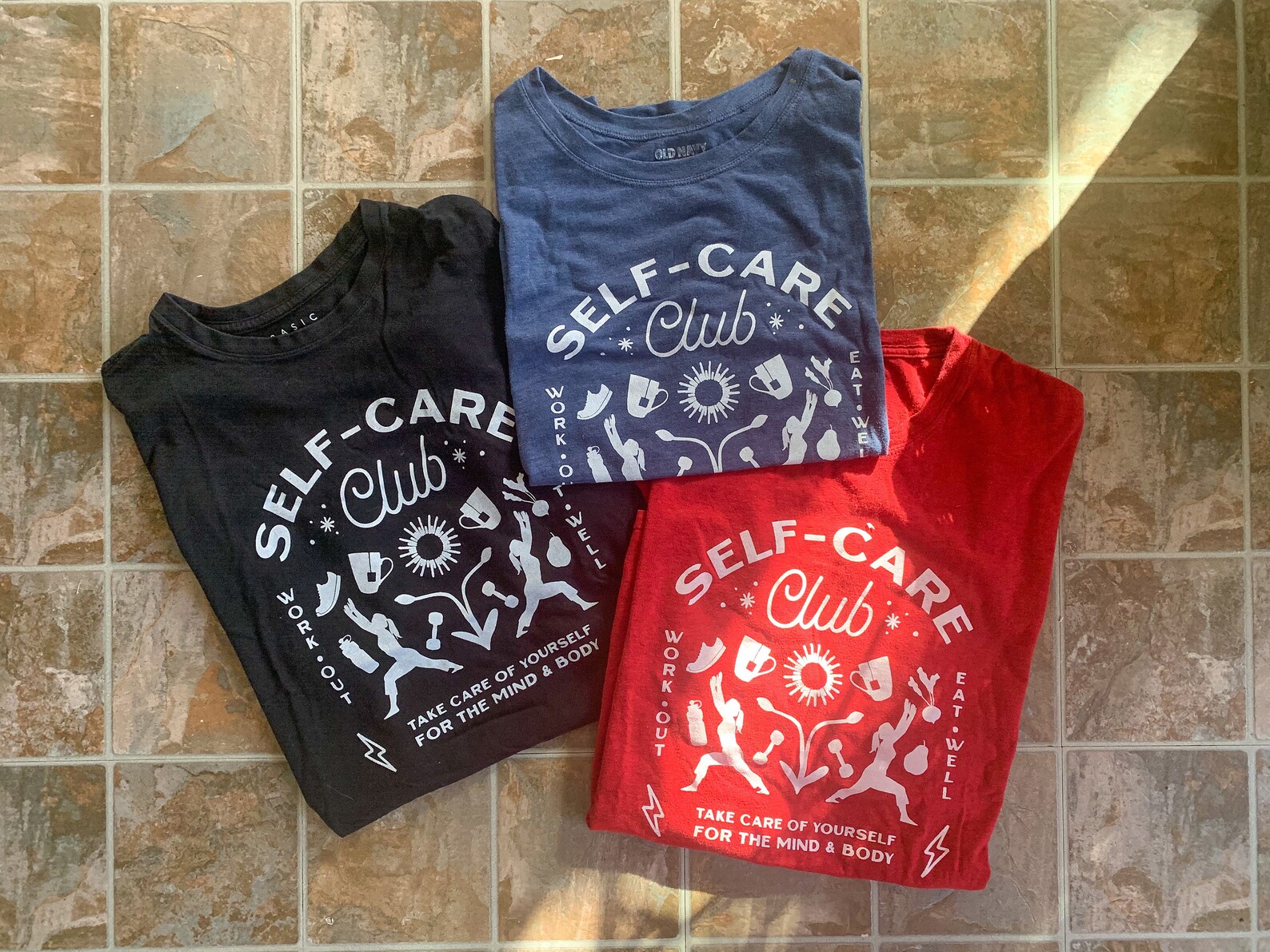 Three t - shirts that say self care club.