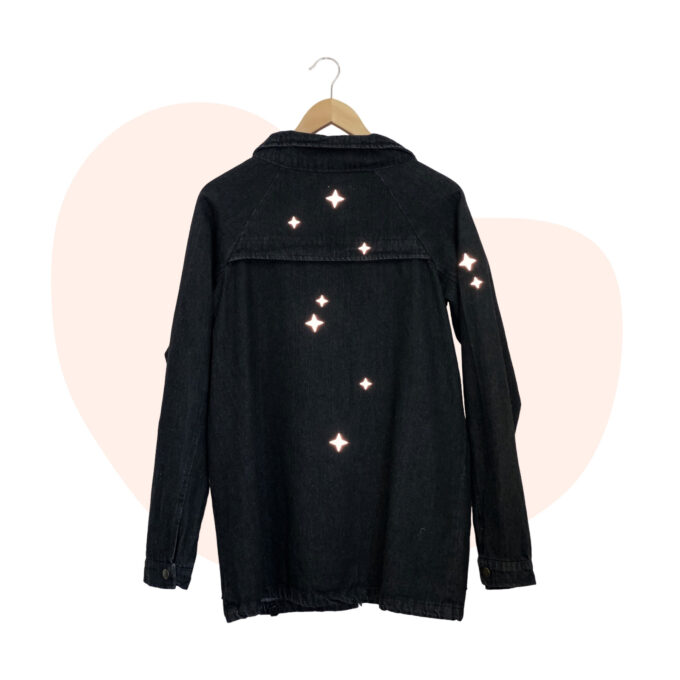 A black denim jacket with stars on it.