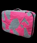 A pink suitcase with black and white checkered pattern.