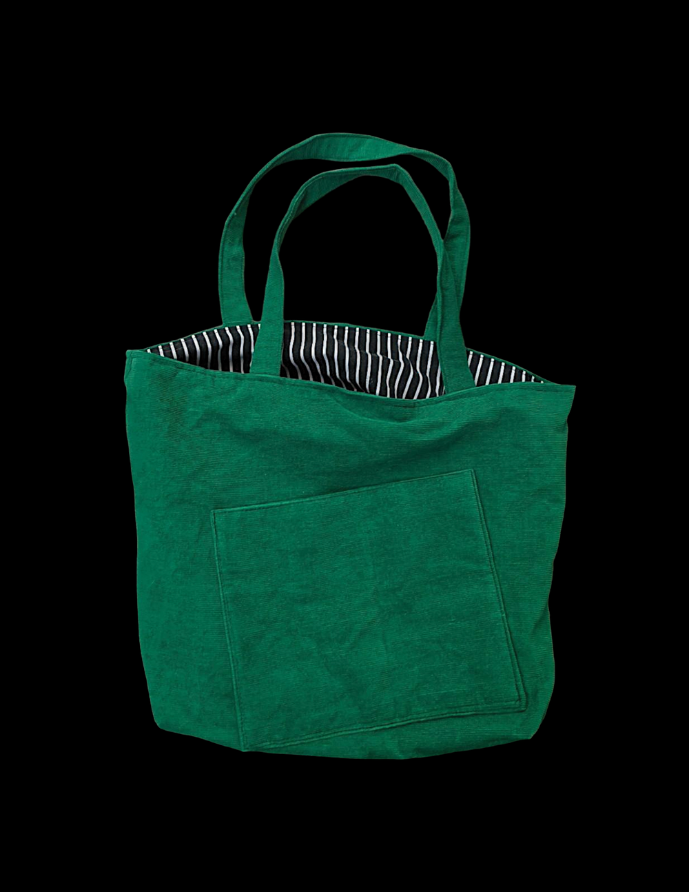 A green tote bag on a black background.