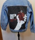 A denim jacket with a hand drawn heart on it.