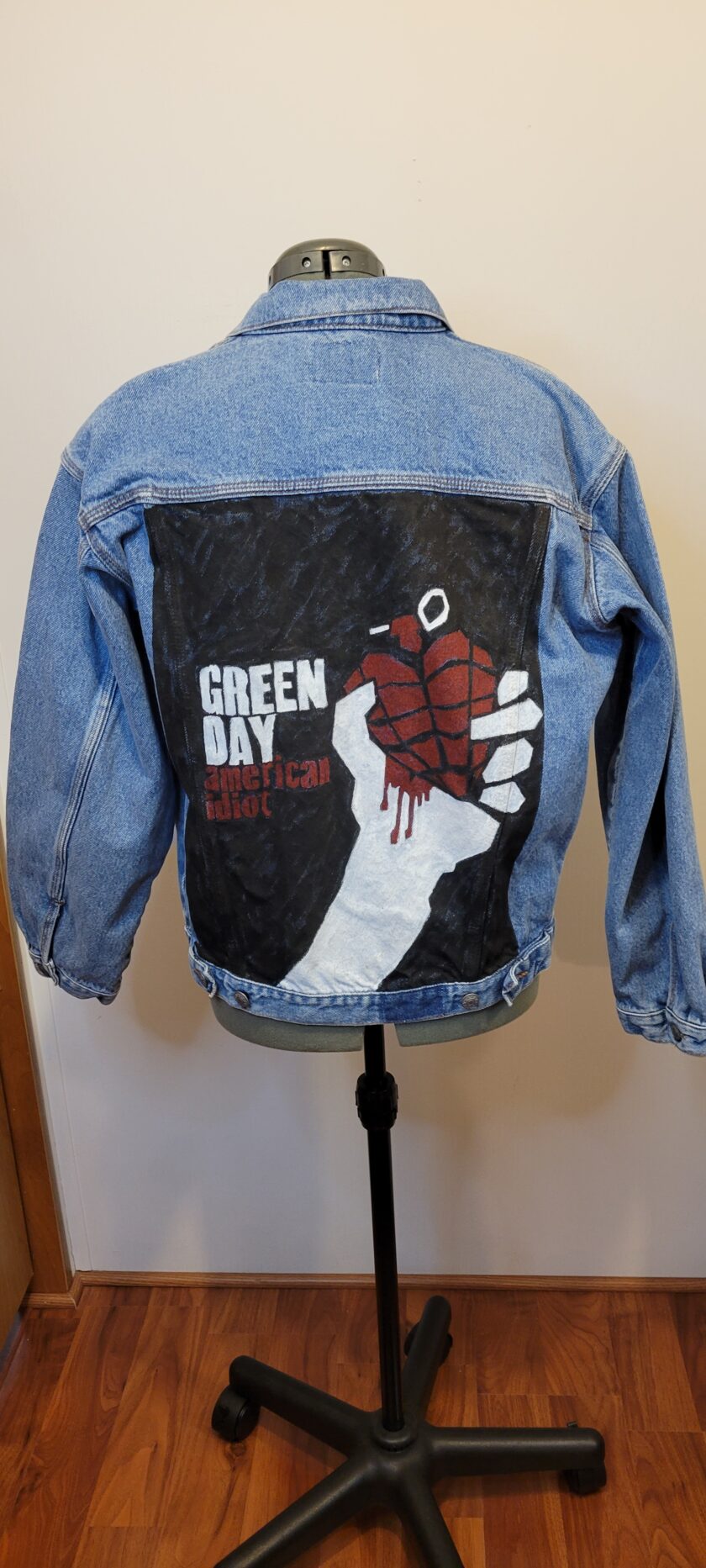 A denim jacket with a hand drawn heart on it.