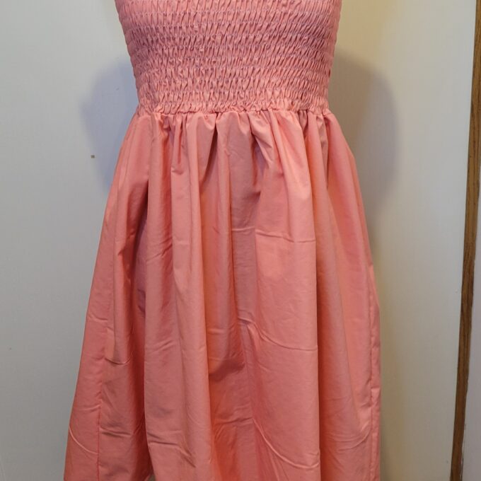 A pink dress on a mannequin.