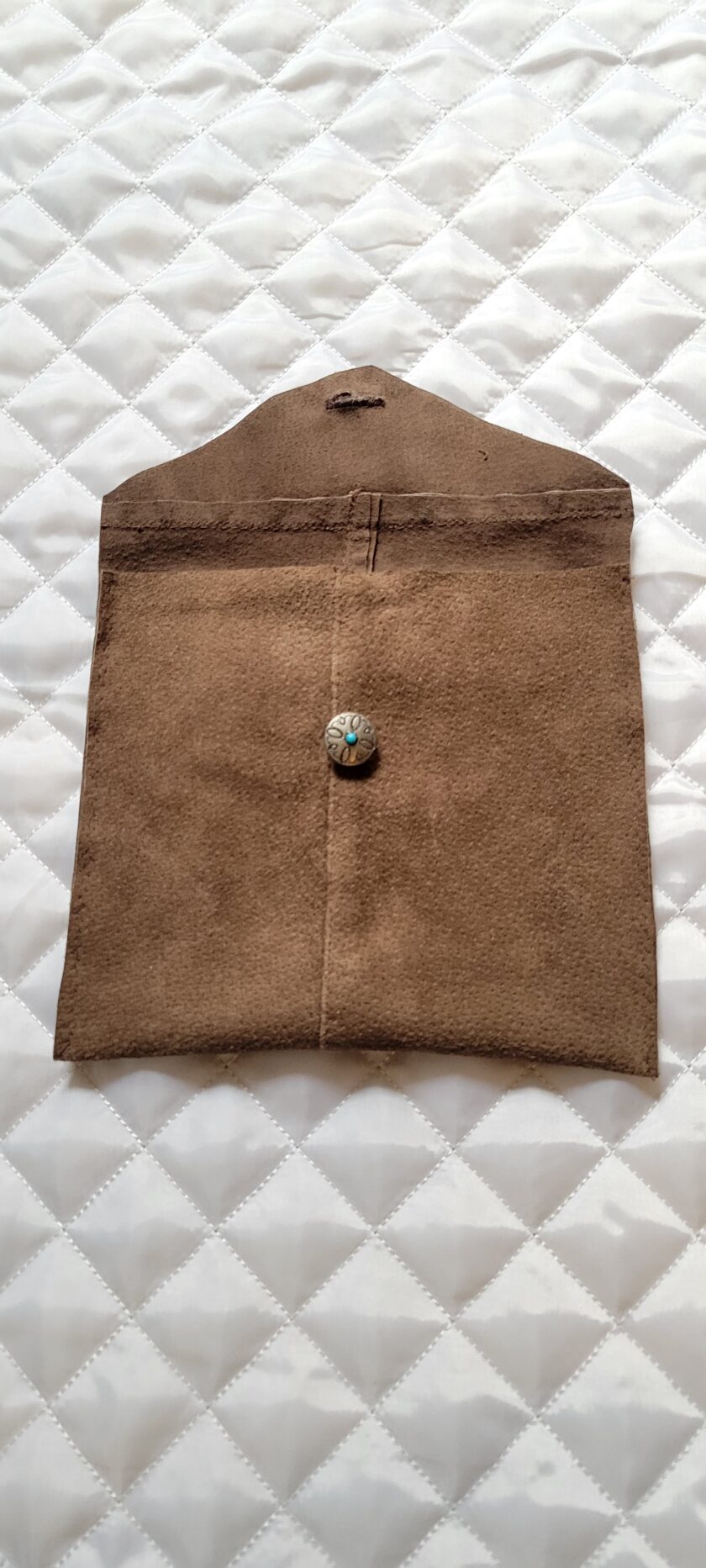 A brown bag with a button on it.