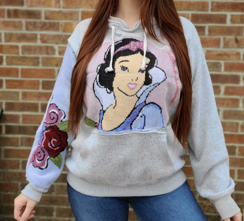 A woman wearing a snow white hoodie.