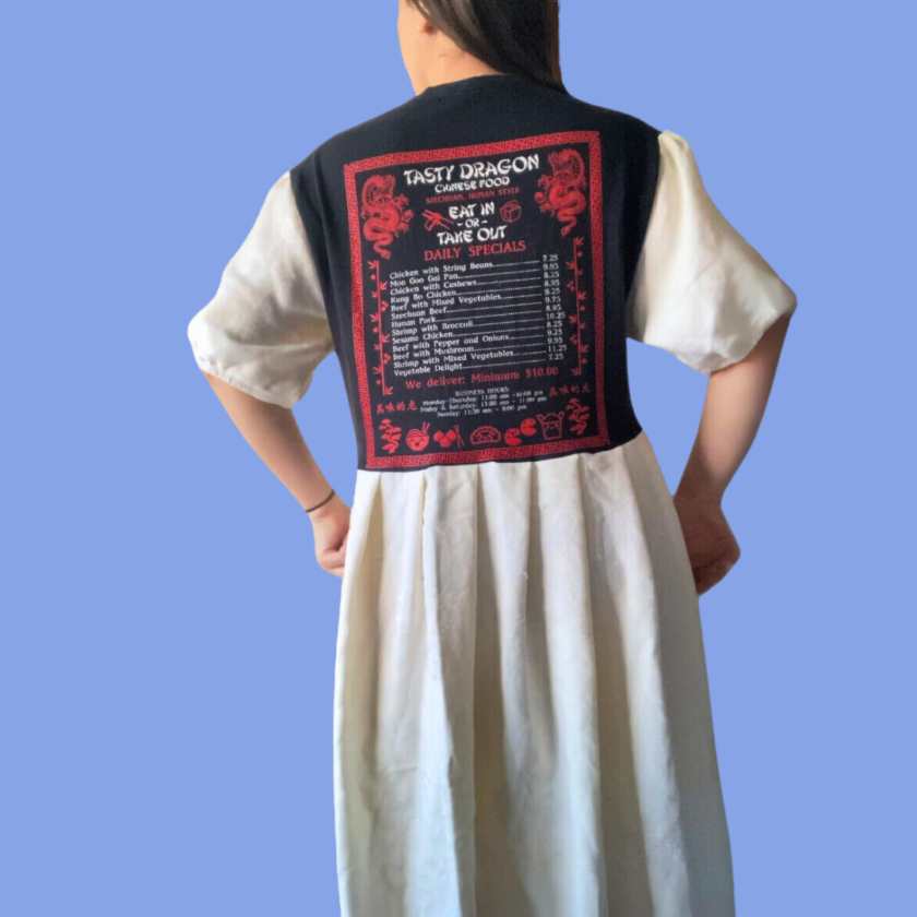 The back of a woman wearing a dress with a black and red design.