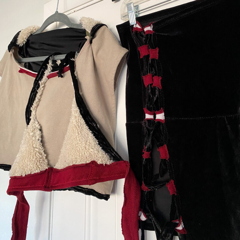 A pair of black and red lingerie hanging on a hanger.