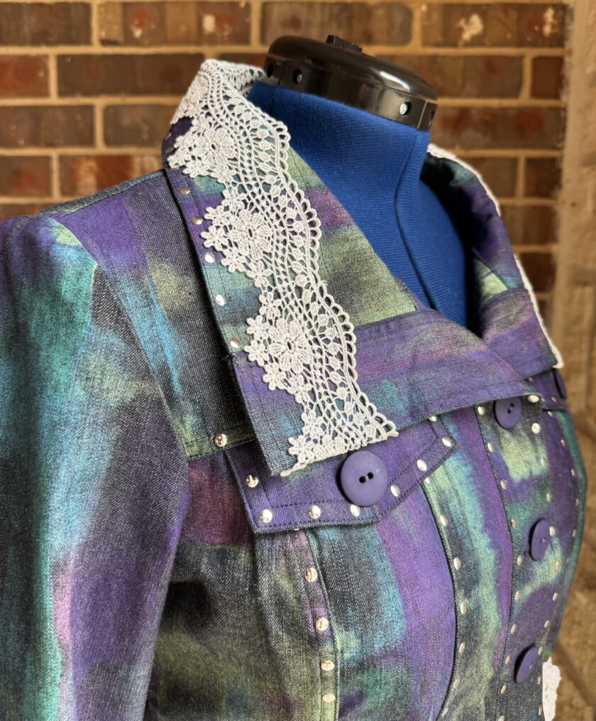 A mannequin with a purple jacket and white lace.