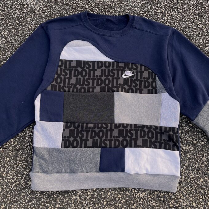A nike sweatshirt with a patch on it.