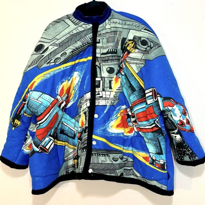 A blue jacket with a star wars design on it.