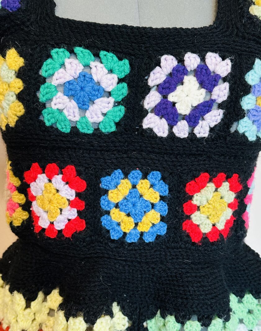 A black crocheted dress with colorful granny squares.
